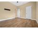 Spacious bedroom with wood-style tile flooring and neutral wall tones at 2602 Stargrass Cir, Clermont, FL 34715