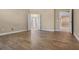 An airy bedroom with wood-style tile flooring, neutral walls, and a bathroom in view at 2602 Stargrass Cir, Clermont, FL 34715