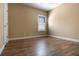 A bedroom features natural light, neutral walls, and wood-style tile flooring at 2602 Stargrass Cir, Clermont, FL 34715