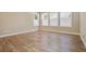 A bright bedroom showcases three shuttered windows and wood-style tile flooring at 2602 Stargrass Cir, Clermont, FL 34715