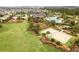 Aerial view featuring community amenities including a pool, sand volleyball court, playground, and green spaces for recreation at 2602 Stargrass Cir, Clermont, FL 34715