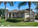 Charming single-Gathering home featuring a two-car garage, manicured lawn and lush landscaping at 2602 Stargrass Cir, Clermont, FL 34715