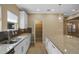 Kitchen featuring granite countertops, pantry, stainless steel appliances, and modern lighting at 2602 Stargrass Cir, Clermont, FL 34715