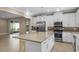 Kitchen features stainless steel appliances, granite countertops, and white cabinets at 2602 Stargrass Cir, Clermont, FL 34715