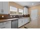 Kitchen with stainless steel appliances, white cabinets, and tiled backsplash, and granite countertops at 2602 Stargrass Cir, Clermont, FL 34715