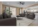 Open concept living room featuring neutral tones, tile flooring, and sliding glass doors to the outdoor space at 2602 Stargrass Cir, Clermont, FL 34715