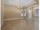 Expansive living room featuring tile floors, neutral paint, decorative windows, and a chandelier at 2602 Stargrass Cir, Clermont, FL 34715