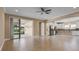 Bright living room with sliding glass doors, tile flooring, and views of the kitchen at 2602 Stargrass Cir, Clermont, FL 34715