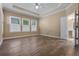 Bright bedroom features wood floors, white shutters, and an en-suite bathroom at 2602 Stargrass Cir, Clermont, FL 34715