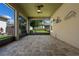 View of the covered and screened lanai with brick floor and a ceiling fan at 2602 Stargrass Cir, Clermont, FL 34715