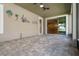 Covered outdoor space with tiled flooring, ceiling fans, and decorative wall art at 2602 Stargrass Cir, Clermont, FL 34715