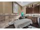 A tranquil spa room featuring a massage table, cabinets, and warm, soothing lighting at 2602 Stargrass Cir, Clermont, FL 34715
