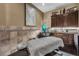 Relaxing spa room featuring a massage table, tiled walls, ambient lighting, and storage cabinets at 2602 Stargrass Cir, Clermont, FL 34715