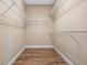 Spacious walk-in closet featuring wood floors and ample storage space at 2602 Stargrass Cir, Clermont, FL 34715
