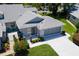 Aerial view of the property with front yard landscaping at 26030 Newcombe Cir, Leesburg, FL 34748