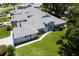 Inviting exterior view shows well-manicured lawn and landscaped walkway to the front door with blue awnings at 26030 Newcombe Cir, Leesburg, FL 34748