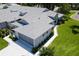 Aerial view of the property showing the attached garage and landscaping at 26030 Newcombe Cir, Leesburg, FL 34748