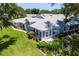 Aerial view of the rear of the property showing the patio and landscaping at 26030 Newcombe Cir, Leesburg, FL 34748
