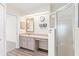 Bathroom featuring a vanity and walk-in shower with a glass enclosure at 26030 Newcombe Cir, Leesburg, FL 34748