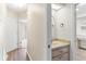 This bathroom features a neutral countertop vanity and a mirror at 26030 Newcombe Cir, Leesburg, FL 34748