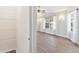 Bedroom featuring two windows with decorative curtains and wood flooring at 26030 Newcombe Cir, Leesburg, FL 34748