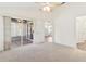 Bright bedroom with a sliding glass door leading to a sunroom at 26030 Newcombe Cir, Leesburg, FL 34748