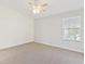 Bedroom with a ceiling fan and natural light coming through the window at 26030 Newcombe Cir, Leesburg, FL 34748