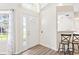 Entryway featuring a white front door with sidelight and transom window at 26030 Newcombe Cir, Leesburg, FL 34748