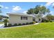 Charming house with lovely landscaped yard and sidewalk pathway at 26030 Newcombe Cir, Leesburg, FL 34748