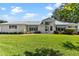 Inviting single-story home with tidy landscaping and well-kept lawn at 26030 Newcombe Cir, Leesburg, FL 34748