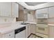 Kitchen featuring modern appliances, countertops, and white cabinetry at 26030 Newcombe Cir, Leesburg, FL 34748