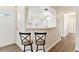 Kitchen view featuring white cabinets and breakfast bar with seating at 26030 Newcombe Cir, Leesburg, FL 34748