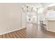 Bright living room featuring wood floors and a decorative chandelier at 26030 Newcombe Cir, Leesburg, FL 34748