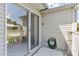 Outdoor patio with sliding glass doors and brick accents at 26030 Newcombe Cir, Leesburg, FL 34748
