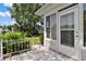 Screened in patio with landscaping and a small fence at 26030 Newcombe Cir, Leesburg, FL 34748