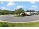Paved parking area with cars at 26030 Newcombe Cir, Leesburg, FL 34748