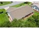 Home aerial showcasing the roof, lawn, and surrounding community at 26608 Racquet Cir, Leesburg, FL 34748