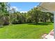 Lush backyard with mature trees providing ample shade and privacy at 26608 Racquet Cir, Leesburg, FL 34748