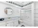 Bathroom with nautical decor, shower/tub combo with sliding glass doors at 26608 Racquet Cir, Leesburg, FL 34748