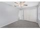 Bedroom with ceiling fan and double door closet at 26608 Racquet Cir, Leesburg, FL 34748