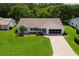 Charming home with well-manicured lawn, landscaping, and paved driveway at 26608 Racquet Cir, Leesburg, FL 34748