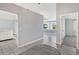 Open hallway featuring neutral paint, leading to other rooms in the home at 26608 Racquet Cir, Leesburg, FL 34748