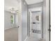 Hallway leading to bedroom and bathroom with coastal decor at 26608 Racquet Cir, Leesburg, FL 34748