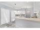 Bright kitchen featuring white cabinets, a breakfast bar, and tile flooring at 26608 Racquet Cir, Leesburg, FL 34748