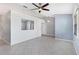 Inviting living room with tile floors, fan, and light fixtures at 26608 Racquet Cir, Leesburg, FL 34748