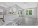 Bright living area with tile flooring, access to the kitchen and screened-in patio at 26608 Racquet Cir, Leesburg, FL 34748