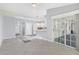 Bright living area connected to the kitchen and featuring tiled floors at 26608 Racquet Cir, Leesburg, FL 34748