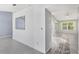 Open-concept living room showcasing tile flooring and airy design, adjacent to the kitchen at 26608 Racquet Cir, Leesburg, FL 34748