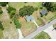 Aerial view of home highlighting its large lot, mature trees, and proximity to the roadway at 2845 County Road 523, Wildwood, FL 34785