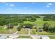 An aerial view of the property showcases the surrounding lush landscape and mature trees at 2845 County Road 523, Wildwood, FL 34785